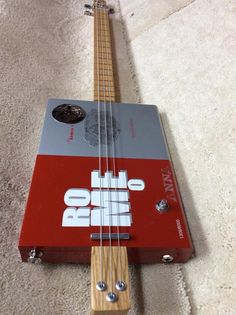 an electric bass guitar laying on the floor