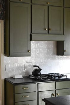 a stove top oven sitting inside of a kitchen