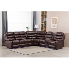 a large sectional sofa with recliners in the middle of it and a rug on the floor