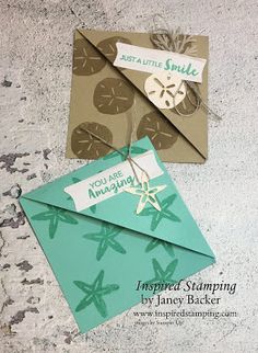 two envelopes that have been made to look like sand dollar signs and starfish on them