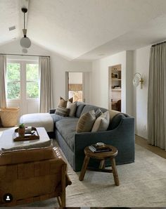 a living room filled with furniture and windows