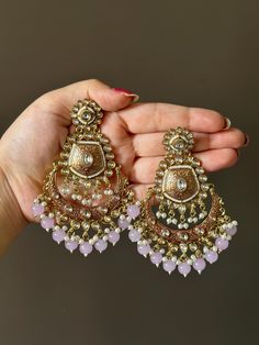 These royal kundan earrings are the perfect match for any festive outfit, especially when you want to add that extra hint of glamour! They feature a high quality to bring a beautiful contrast to the overall look. The earrings have a push-back closure and are comfortable to wear for long durations. Gold Bollywood Chandelier Earrings For Party, Bollywood Chandelier Earrings With Intricate Design For Celebration, Bollywood Style Chandelier Earrings With Intricate Design For Celebrations, Bollywood Style Intricate Chandelier Earrings For Celebrations, Gold Chandbali Bridal Earrings For Party, Gold Kundan Bridal Earrings For Party, Kundan Bridal Drop Earrings For Party, Heavy Chandelier Earrings For Eid Party, Gold Bollywood Bridal Earrings For Party