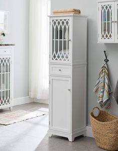 a tall white cabinet in the corner of a room