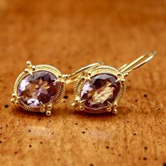 Renaissance jewelry is splendidly reborn. Our faceted amethyst ensemble belongs at a ball, or at least at a local disco. 24k gold over sterling silver granulated settings augment the brilliant sparkle of the faceted stones. European backs. Size: 1 Inch. Luxury Gold Amethyst Earrings, Exquisite Gold Earrings With Gemstone Accents, Faceted Yellow Gold Oval Earrings, Yellow Gold Faceted Oval Earrings, Heirloom Faceted Gold Jewelry, Gold Amethyst Earrings Fine Jewelry, Gold Amethyst Gemstone Earrings, Gold Amethyst Round Earrings, Exquisite Amethyst Yellow Gold Jewelry