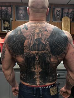 the back of a man with tattoos on his body