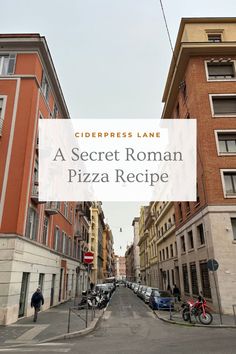 a street lined with tall brick buildings and parked cars next to each other in front of the words, a secret roman pizza recipe