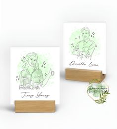 two greeting cards on wooden stand with green ink