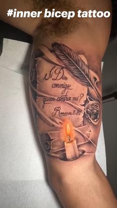 a man's arm with a candle and some writing on it