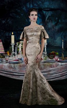 a woman standing in front of a table with candles