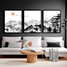 three black and white paintings in a living room