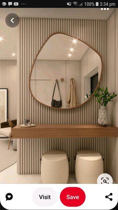 there is a mirror and stools in this bathroom with beige stripes on the wall