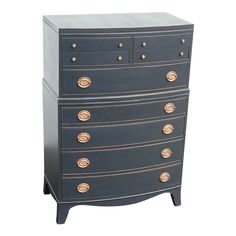 a black dresser with gold knobs on the top and bottom drawers, against a white background