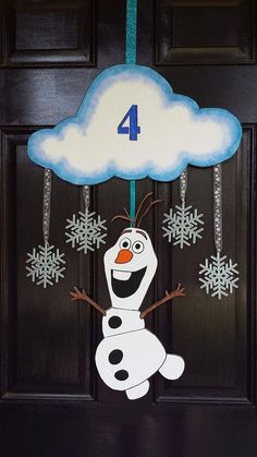 the door is decorated with an image of a snowman and number four on it