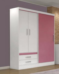 a white and pink wardrobe with drawers in a room next to a brick wall on the floor