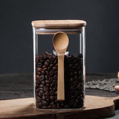 a jar filled with coffee beans and a wooden spoon