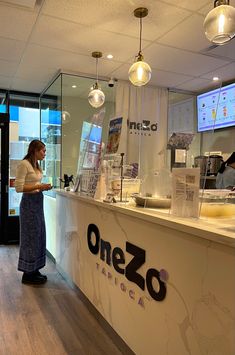 a woman standing in front of a counter