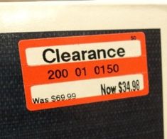 a close up of a price label on a refrigerator door that is black and orange