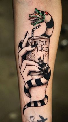 a tattoo on the leg of a person holding a bottle with a snake coming out of it