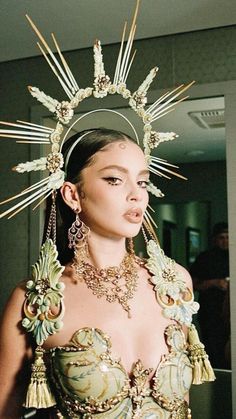 a woman wearing an elaborate headdress and jewelry