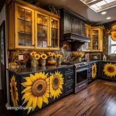 a kitchen with sunflowers painted on the cabinets and counter tops, along with wooden floors