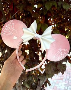 The cutest Spooky Mouse Spider can now join you on your park adventures this spooky season! These pink velvet ears are paired with a white faux leather bow and have a one-of-a-kind mouse spider that was completely hand drawn, and transferred onto vinyl for a magical touch! ✦Interested in these ears in black velvet? Head over to our "Velvet Ears" tab to find them with the options of a white or black faux leather bow! ✦The placement and pattern of spiderwebs will slightly vary from each handmade pair, adding to the unique magic of each one! ✦Do you tend to experience sliding with Mouse Ears? Not sure if you'll need grip? Be sure to purchase our Add-On 'Self Assembly Headband Grip' option before checkout. You'll receive two rubber headband grip strips that you can place anywhere you feel nece Halloween Minnie Ears, Marie Disneybound, Halloween Disney Ears, Christmas Disney Ears, Halloween Mickey Ears, Mouse Spider, Bat Bow, Disney Savings, Goth Disney