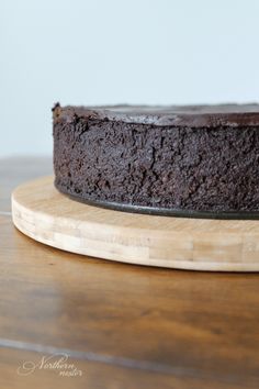 a chocolate cake sitting on top of a wooden cutting board