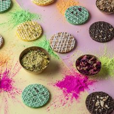 colorful powdered cookies are arranged on a table