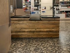 the front desk of a pharmacy is made out of pallet boards and wood planks