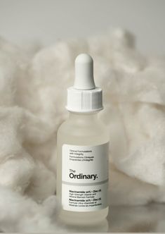 a bottle of the ordinary on top of a pile of white fluffy material with a small dropper