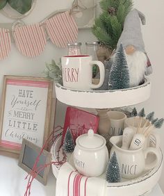 three tiered trays with mugs and other items on top of each shelf