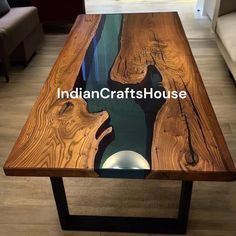 the table is made out of wood and has glass on it, with an image of a river running through it