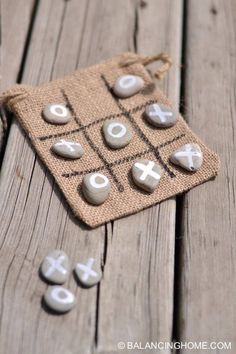 a cloth bag with buttons and letters on it