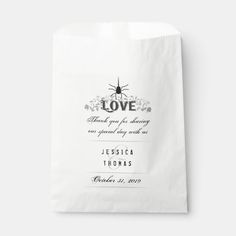 a white paper bag with the words love on it and an image of a spider