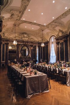 a dining room with tables and chairs set up for a formal function in the center