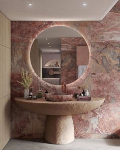 a bathroom with a round mirror on the wall and marble counter top in front of it