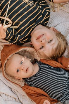 two young children laying on top of each other