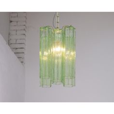 a green chandelier hanging from a ceiling