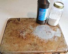 an old suitcase with two jars and salt on the top sitting on a white table