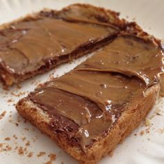 two pieces of bread with chocolate frosting on them