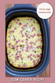 an egg casserole in a slow cooker with ham and cheese on top