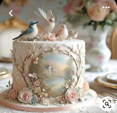 there is a cake decorated with birds and flowers