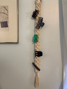 there is a wall hanging made out of hairbrushes and other items on the wall