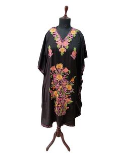 Crush cotton embroidered Kaftan with great fall and soft in touch. Actual length 43 Inch Free size color black with multi color embroidery Made in Kashmir -India Traditional Black Free Size Kaftan, Black Long Kaftan With Intricate Embroidery, Black Bohemian Kaftan With Floral Embroidery, Summer Black Kaftan With Floral Embroidery, Black Long Kaftan With Floral Embroidery, Black Floral Embroidered Kaftan For Festivals, Black Long Sleeve Kaftan With Floral Embroidery, Long Black Kaftan For Spring, Black Kaftan For Festivals