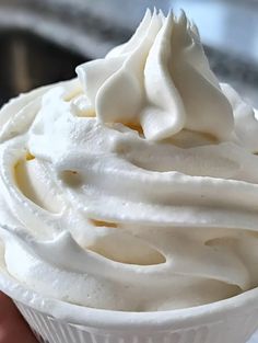 a close up of a cupcake with white frosting on it's surface