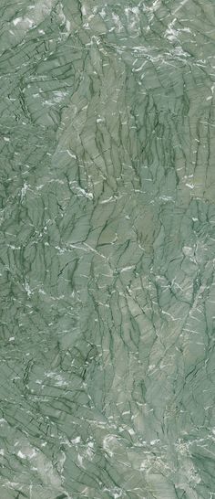 a green marble textured wallpaper with white and gray streaks on it's surface