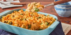 a blue casserole dish with broccoli and chicken