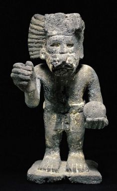 an ancient statue is shown against a black background with the image of a man holding something in his hand