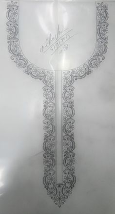 the back side of a white sheet with an ornate design on it, in silver foil