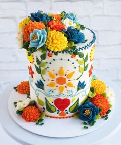 a cake decorated with flowers on top of a white plate