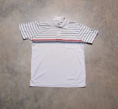 You are looking at a great vintage 80s polo shirt by Hampton Athletic Club. Excellent vintage condition. Fits like a S/M. Please see actual measurements below.  Chest, pit to pit: 19" Length, from the nape: 25" Sleeve, from the shoulder: 8" If you would like to see additional photos or have any other questions, please do not hesitate to ask, and thanks for looking! Shipping disclaimer: All domestic orders under 16oz ship USPS first class mail. All domestic orders over 16oz ship USPS priority mai Sporty Collared Polo Shirt With Three Stripes, Retro Striped Polo Shirt With Polo Collar, Retro Striped Polo Shirt, Sporty Striped Cotton Polo Shirt, Sporty Striped Collared Polo Shirt, Retro Cotton Polo Shirt With Striped Collar, Vintage Striped Collared Polo Shirt, Sporty Striped Short Sleeve Polo Shirt, Vintage Striped Short Sleeve Polo Shirt